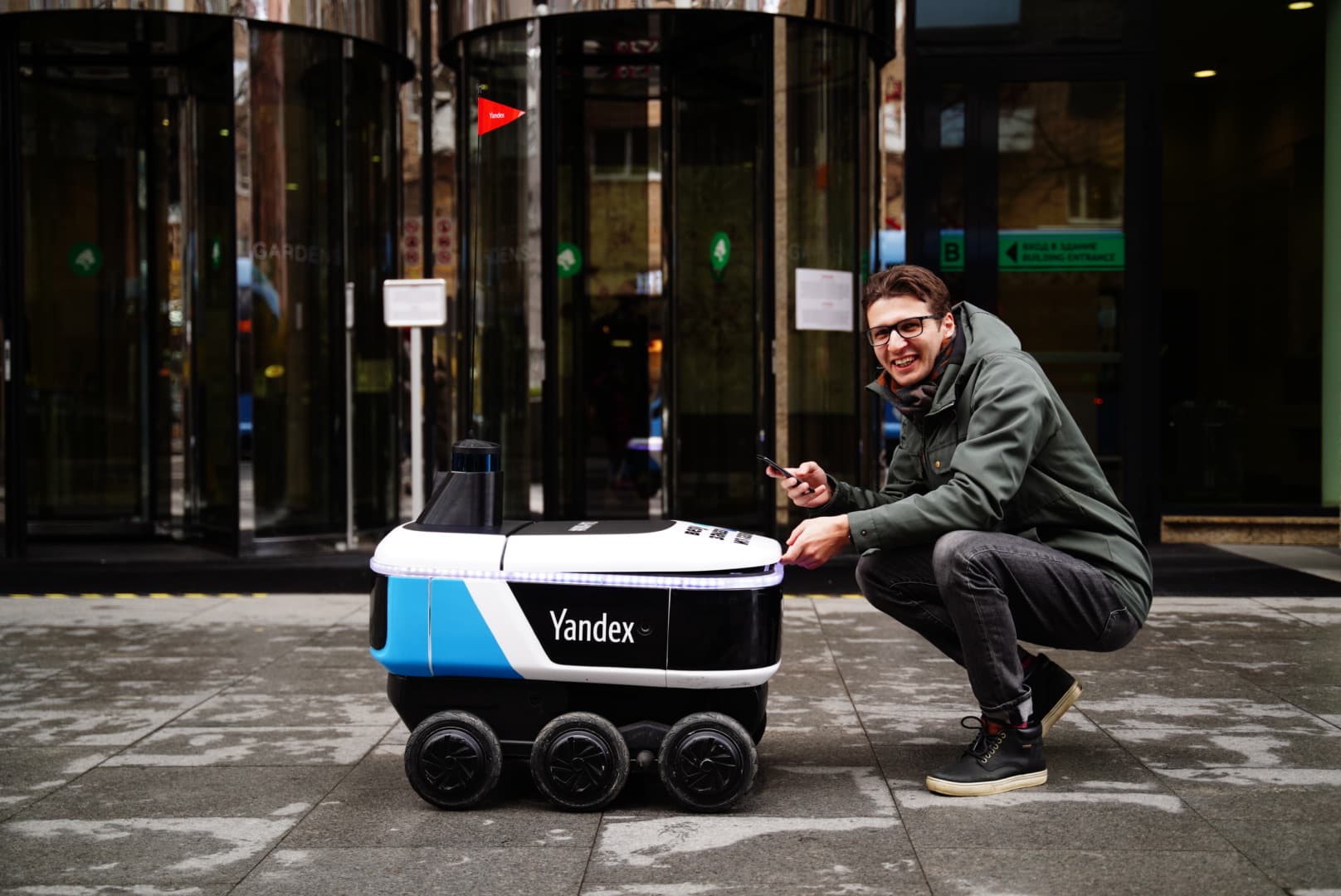 Evgeny Savin with a Yandex autonomous delivery robot